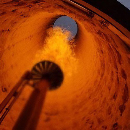Inside view of a gas burner flame inside a circular chamber.
